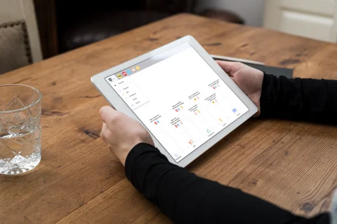 person with iPad viewing timeline with graphic icons